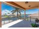 Spacious balcony featuring tile flooring and stunning views of the canal and neighboring homes at 1367 Grebe Dr, Punta Gorda, FL 33950