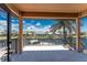 Balcony with tile floor and metal railing overlooking a canal with boat, surrounded by palm trees at 1367 Grebe Dr, Punta Gorda, FL 33950