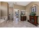 Bathroom showing the tile floor, corner tub, shower, and wood fireplace at 1367 Grebe Dr, Punta Gorda, FL 33950