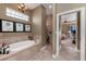 Bathroom with soaking tub, tiled shower, and view of the Primary bedroom at 1367 Grebe Dr, Punta Gorda, FL 33950