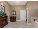 Bathroom featuring a vanity, fireplace, neutral tile flooring, and doorway at 1367 Grebe Dr, Punta Gorda, FL 33950