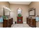 Elegant bathroom with dual vanities, granite countertops, and a charming fireplace feature at 1367 Grebe Dr, Punta Gorda, FL 33950