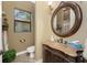 Elegant half bath featuring a vanity with a decorative mirror and stylish fixtures at 1367 Grebe Dr, Punta Gorda, FL 33950