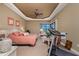 Spacious bedroom featuring a tray ceiling, ceiling fan, and comfortable furnishings for relaxation and rest at 1367 Grebe Dr, Punta Gorda, FL 33950
