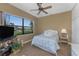 Cozy bedroom featuring a ceiling fan and a window with neighborhood views at 1367 Grebe Dr, Punta Gorda, FL 33950