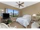 Cozy bedroom featuring a ceiling fan and a window with neighborhood views at 1367 Grebe Dr, Punta Gorda, FL 33950