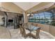 Dining room with glass table, seating for six, chandelier, and large sliding glass doors at 1367 Grebe Dr, Punta Gorda, FL 33950