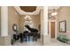 Grand foyer featuring tile floors, a baby grand piano, soaring ceilings, and custom lighting at 1367 Grebe Dr, Punta Gorda, FL 33950
