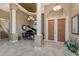 Grand foyer featuring tile floors, a baby grand piano, soaring ceilings, and custom lighting at 1367 Grebe Dr, Punta Gorda, FL 33950