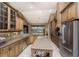 A gourmet kitchen with stainless steel appliances, custom cabinets, and granite countertops at 1367 Grebe Dr, Punta Gorda, FL 33950