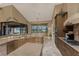 A view of a modern kitchen featuring wood cabinets, granite countertops, and stainless steel appliances at 1367 Grebe Dr, Punta Gorda, FL 33950