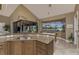 Stylish kitchen features granite counters, wood cabinetry, and a view to the canal at 1367 Grebe Dr, Punta Gorda, FL 33950