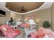 Bright main bedroom with tray ceiling, ceiling fan, and comfortable seating area at 1367 Grebe Dr, Punta Gorda, FL 33950