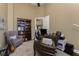Inviting home office featuring a cozy chair, bookcase, and functional desk for a productive work environment at 1367 Grebe Dr, Punta Gorda, FL 33950