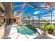 Enclosed pool area offers a relaxing retreat with waterfront views and lush tropical landscaping at 1367 Grebe Dr, Punta Gorda, FL 33950