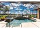 Stunning screened-in pool and spa area with beautiful views of the surrounding waterfront and tropical plants at 1367 Grebe Dr, Punta Gorda, FL 33950