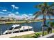 Picturesque waterfront view with a private boat dock, lush landscaping, and clear blue skies, offering serene living at 1367 Grebe Dr, Punta Gorda, FL 33950