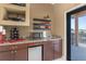 Charming wet bar area with granite countertops, wine rack, microwave, and mini fridge, ideal for entertaining guests at 1367 Grebe Dr, Punta Gorda, FL 33950