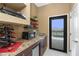 Elegant wet bar area with sleek countertops, modern appliances, and pool view, perfect for outdoor entertainment at 1367 Grebe Dr, Punta Gorda, FL 33950