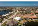 Waterfront home featuring lush landscaping, a canal, and a backyard dock at 1374 Grebe Dr, Punta Gorda, FL 33950