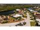 Waterfront home featuring lush landscaping, a canal, and a backyard dock at 1374 Grebe Dr, Punta Gorda, FL 33950