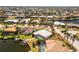 Waterfront home featuring lush landscaping, a canal, and a backyard pool enclosure at 1374 Grebe Dr, Punta Gorda, FL 33950