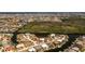 Waterfront home featuring lush landscaping, a canal, and a backyard dock at 1374 Grebe Dr, Punta Gorda, FL 33950