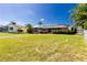 A spacious backyard with lush green grass and palm trees at 1374 Grebe Dr, Punta Gorda, FL 33950