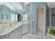 Bright bathroom featuring double sinks, spacious shower, and white cabinetry at 1374 Grebe Dr, Punta Gorda, FL 33950