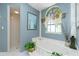 Relaxing bathroom featuring a bathtub with a window view and stylish decor at 1374 Grebe Dr, Punta Gorda, FL 33950