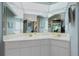 Spacious bathroom with a double vanity, complemented by a large mirror and ample lighting, creating a functional area at 1374 Grebe Dr, Punta Gorda, FL 33950