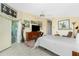 Well-lit bedroom with a ceiling fan, dresser, and decoratively adorned walls at 1374 Grebe Dr, Punta Gorda, FL 33950