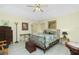Comfortable bedroom with elegant decor, featuring a decorative bed frame, stylish lighting, and classic furnishings at 1374 Grebe Dr, Punta Gorda, FL 33950