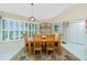Cozy dining room featuring natural light, shuttered windows, and a decorative rug under the wooden dining set at 1374 Grebe Dr, Punta Gorda, FL 33950