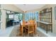Inviting dining area with a wooden table, decorative rug, and a view of the pool through sliding glass doors at 1374 Grebe Dr, Punta Gorda, FL 33950
