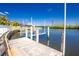View of the dock, boat lift, and canal at 1374 Grebe Dr, Punta Gorda, FL 33950