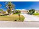 Charming home with a well-manicured lawn, mature landscaping, and a spacious driveway at 1374 Grebe Dr, Punta Gorda, FL 33950