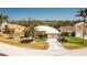 Beautiful home boasts a white tile roof, lush landscaping, and a circular driveway at 1374 Grebe Dr, Punta Gorda, FL 33950