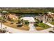 Beautiful home boasts a white tile roof, lush landscaping, and a circular driveway at 1374 Grebe Dr, Punta Gorda, FL 33950