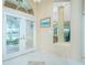 Bright foyer featuring tiled floors, arched transom windows and decorative glass double doors at 1374 Grebe Dr, Punta Gorda, FL 33950