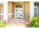 Elegant entryway with tiled porch and decorative glass double doors framed by stately pillars at 1374 Grebe Dr, Punta Gorda, FL 33950
