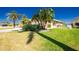 Well-maintained front yard with mature landscaping and a charming fence at 1374 Grebe Dr, Punta Gorda, FL 33950