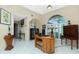 Cozy home office with a vintage desk, arched window, and sophisticated decorative items at 1374 Grebe Dr, Punta Gorda, FL 33950