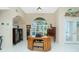 Well-appointed home office showcases a classic desk, built-in storage, and lots of natural light at 1374 Grebe Dr, Punta Gorda, FL 33950