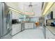 Spacious kitchen featuring stainless steel appliances, white cabinetry, and bright, open layout at 1374 Grebe Dr, Punta Gorda, FL 33950
