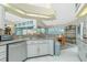 Open kitchen design with granite countertops, white cabinets and eat-in dining area at 1374 Grebe Dr, Punta Gorda, FL 33950