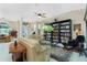 Bright living room with comfortable seating, a decorative rug, and an extensive built-in bookshelf at 1374 Grebe Dr, Punta Gorda, FL 33950