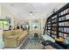 Inviting living room featuring plush seating, a stylish rug, and a large bookcase filled with books at 1374 Grebe Dr, Punta Gorda, FL 33950