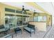 A covered patio with brick flooring, ceiling fans, a seating area, and a view of the canal and pool at 1374 Grebe Dr, Punta Gorda, FL 33950