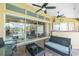A covered patio with brick flooring, ceiling fans, a seating area, and a view of the canal and pool at 1374 Grebe Dr, Punta Gorda, FL 33950